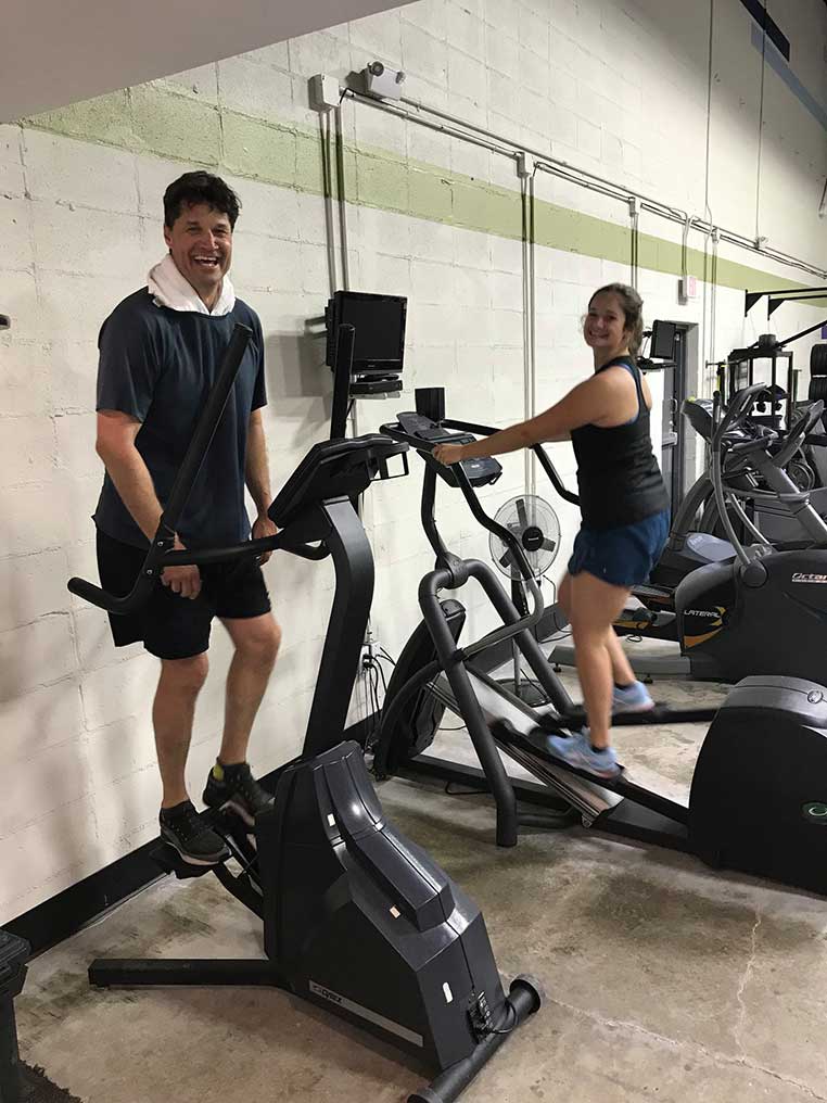 Husband and wife on stepper at Personal Edge Fitness