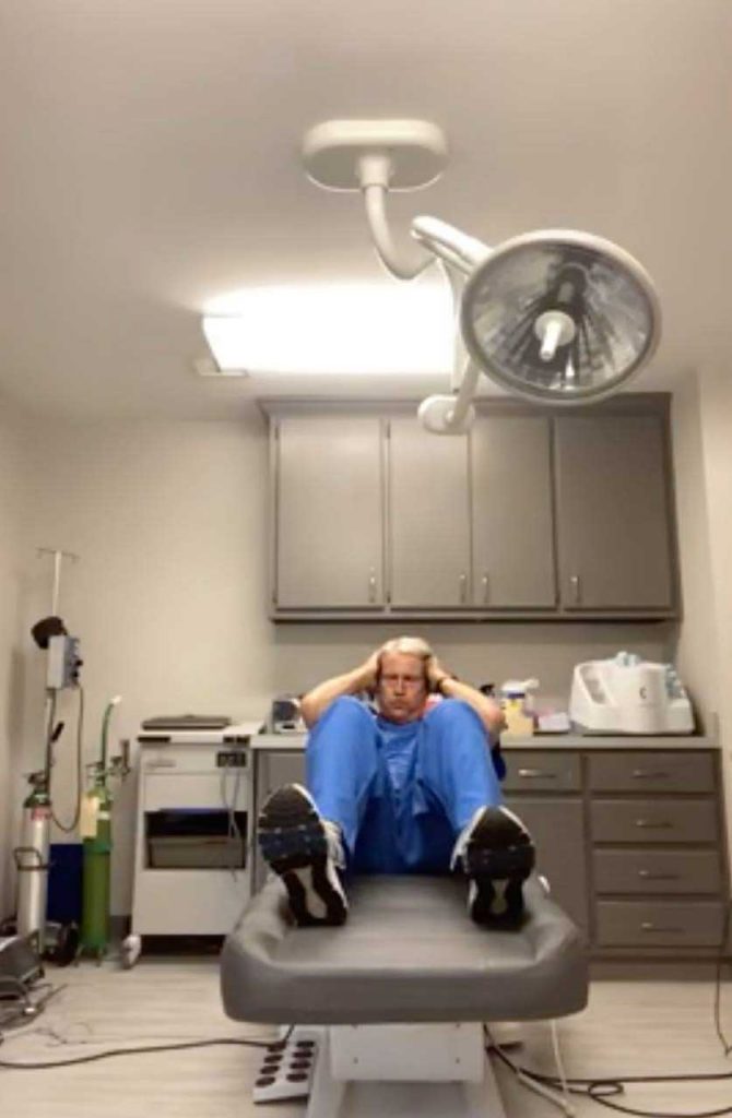 A doctor working out his core remotely at the hospital
